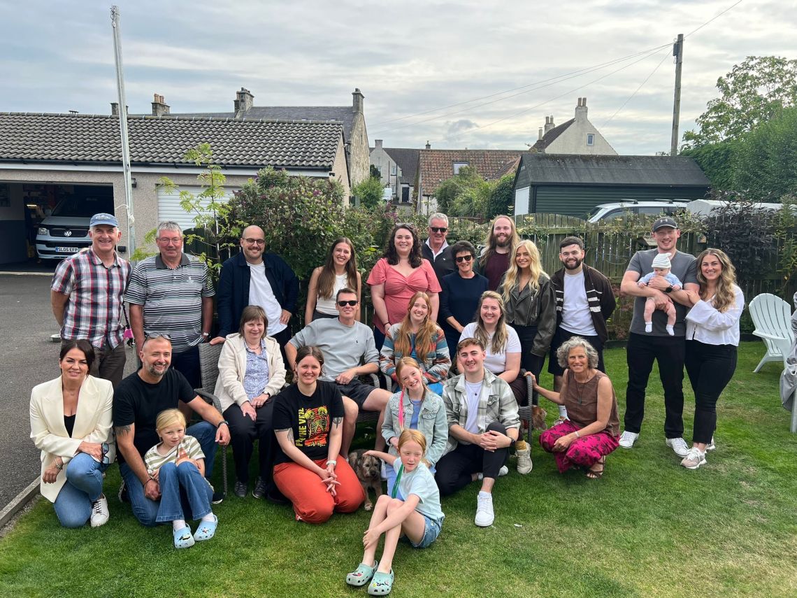 The 1Let team and families enjoying the 2025 summer BBQ together in the garden.
